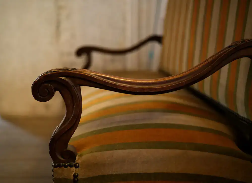 Close up detail of fabric and wood texture on an armchair