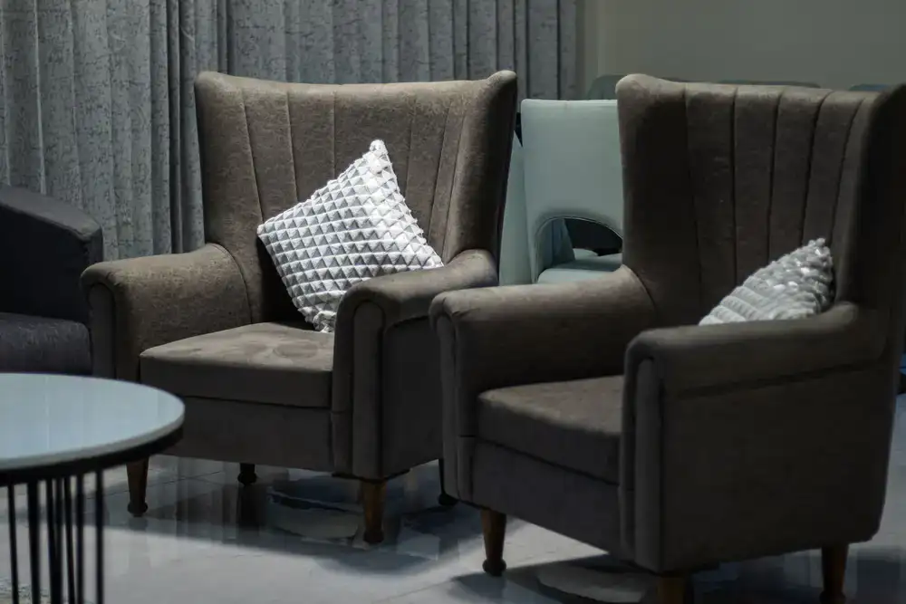 Comfortable upholstered armchair with wooden legs